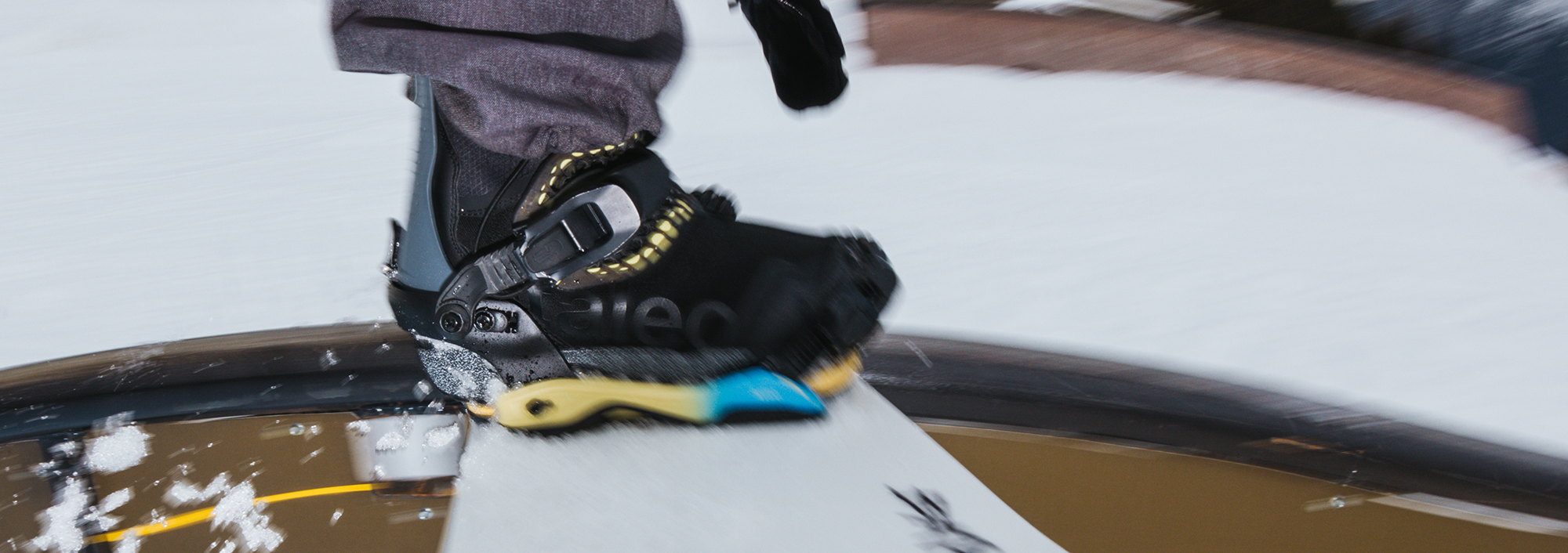 Bataleon mens snowboard bindings being used while riding a rail.