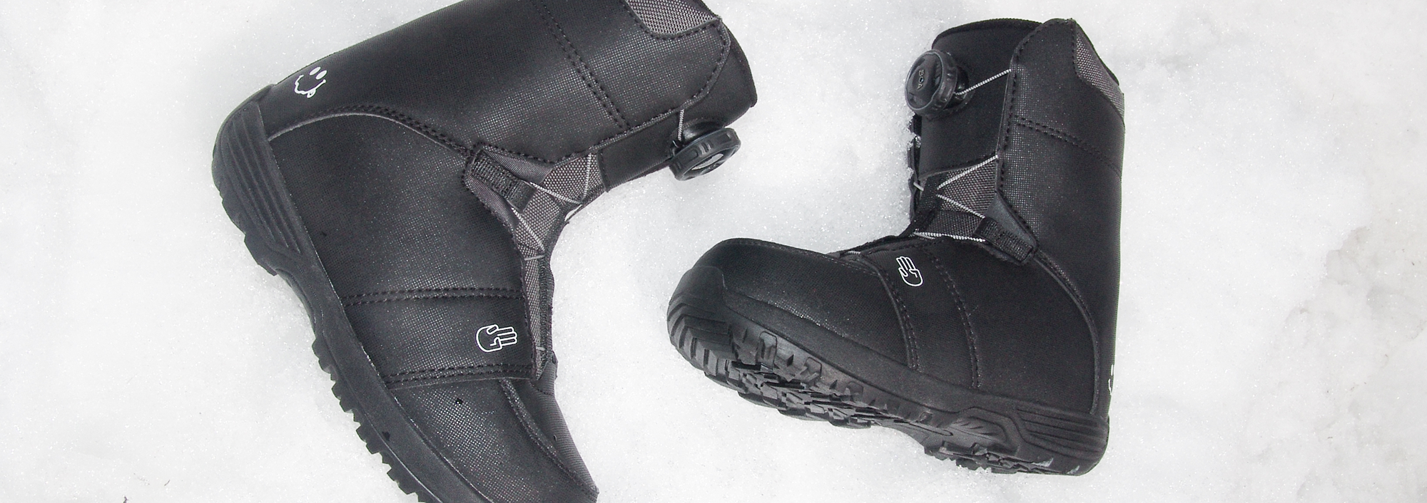 Youth snowboard boots laying in the snow